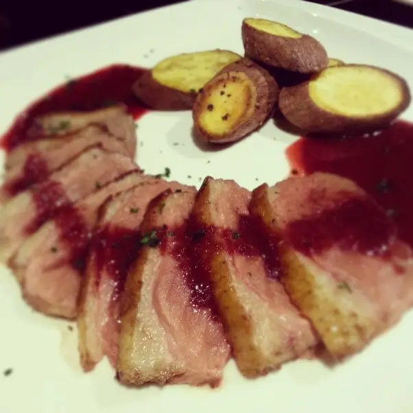 Baked French duck breast with sweet potatoes & berry sauce