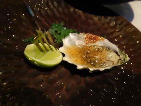 Wild ocean oysters on shell with smoky chipotle chili and ponzu tapioca caviar