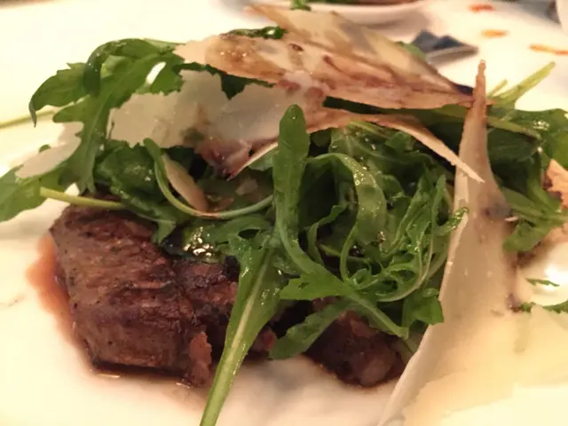 Covered with large pieces of Parmesan cheese, rocket leaves and vinegar.  