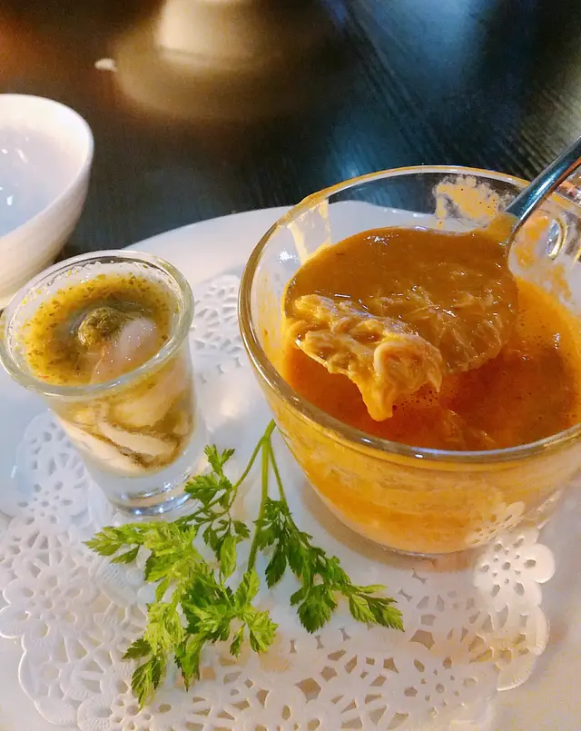 Crab Bisque accompanied by Oyster Shooter