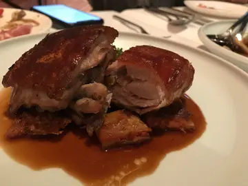 Crispy suckling pig with potato and tomato cake