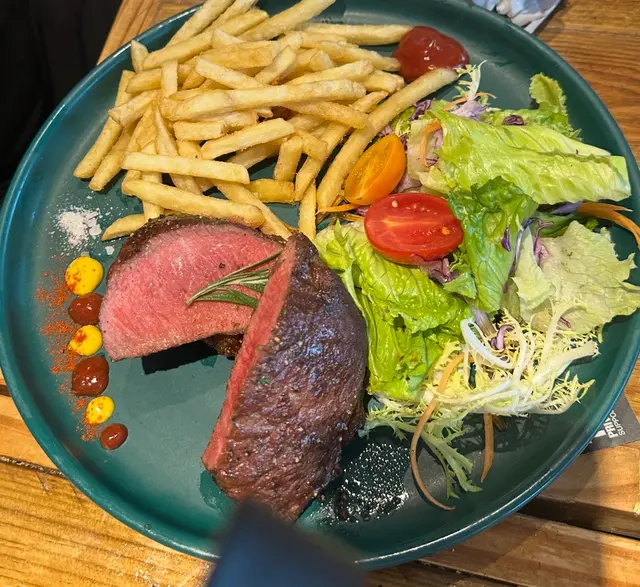 呢塊美國牛扒認真無得彈!一上枱已經聞到陣陣炭烤香,切開見到粉嫩嘅肉色,啲肉汁多到爆棚!
我叫咗五成熟,真係啱啱好。外面層皮煎到脆卜卜,裡面啲肉就軟淋淋,入口即化。牛味超濃,仲有陣淡淡嘅油脂香,咬落去勁juicy,啲肉汁係口裡面爆出嚟,正到呢!
配埋薯條,佢哋啲薯條真係好脆,簡直係完美配搭。雖然價錢貴少少,但係質素真係對得住個價,食完大滿足!各位牛魔王,呢塊牛扒絕對值得試吓!