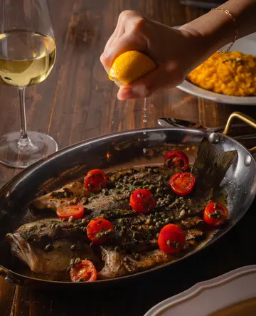 Butterfly seabass, cherry tomato, capers, basil, in white wine sauce (for sharing)